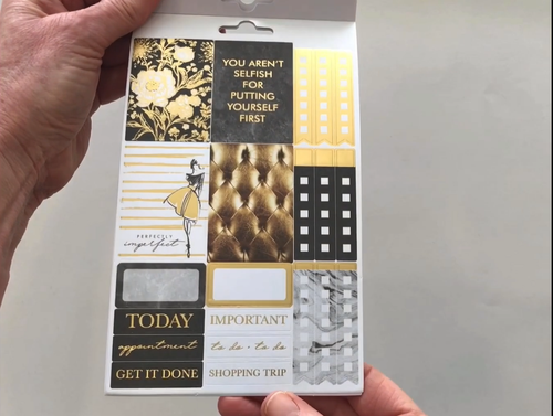 Female hands pick up and flip through the pages of the "5th Avenue" planner stickers booklet to show each page of stickers in detail. There are four pages in this sticker book by Paper House Productions.