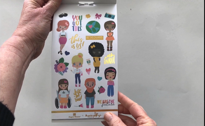 Female hands pick up and flip through the pages of the "Just Be You" planner stickers booklet to show each page of stickers in detail. There are four pages in this sticker book by Paper House Productions.