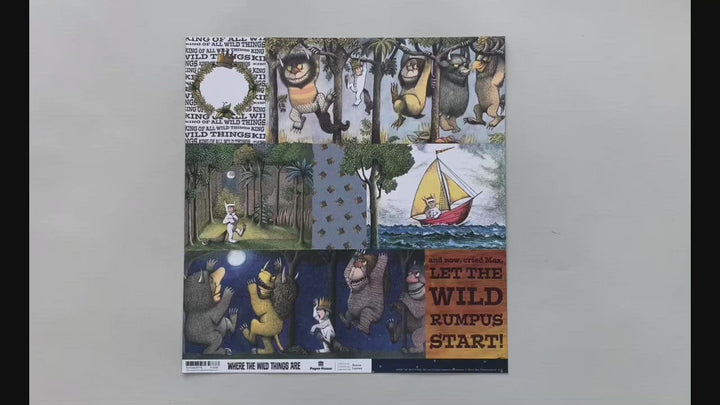 Female hands pick up scrapbook paper featuring Where the Wild Things Are tags on one side and a pattern of stars on the other side.