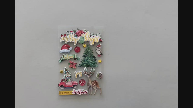 Female hands pick up and show front and back details of 3D scrapbook stickers featuring watercolor christmas tree, santa hats, and reindeer with gold details.