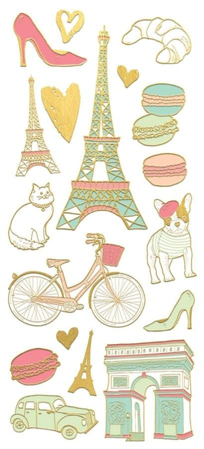 foil stickers featuring illustrated Eiffel Towers, croissants, french bulldog with gold details, shown on white background. 