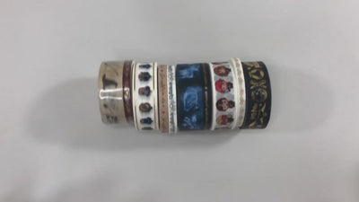 rolls of washi tape shown on white surface and being stretched out by hands to display the various Harry Potter images.