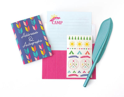 Happy Camper kids stationery image of address book, sticker sheet, note paper, envelope, and feather pen featuring words, tents and graphic illustrations.