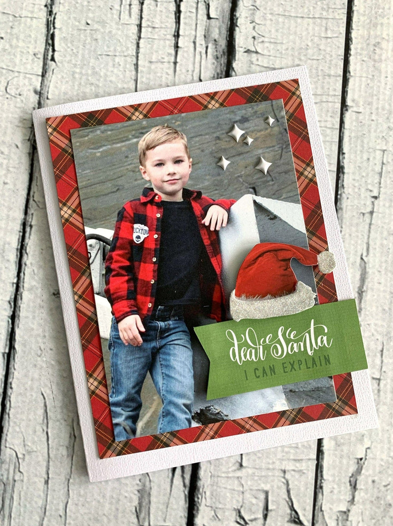 Christmas card featuring photo of boy dressed in a red and black plaid flannel shirt and jeans. 