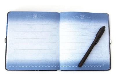 Harry Potter Invisible Ink locking diary shown open featuring blue lined pages and a black pen.