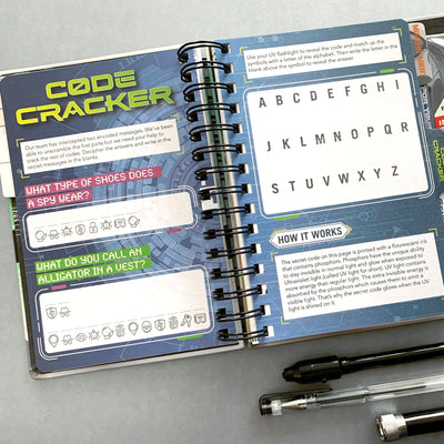 kids journal featuring the Code Cracker open spread with 3 pens, shown on gray background.