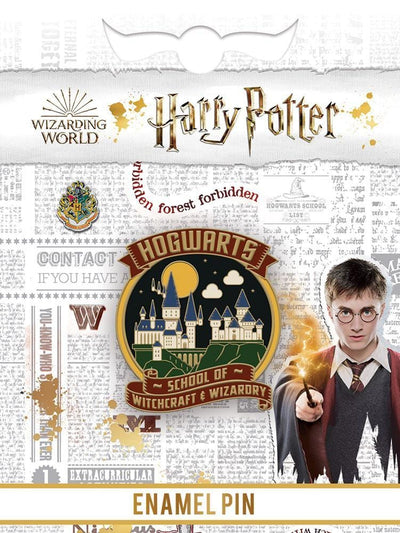 Hogwarts School of Witchcraft & Wizardry cool enamel pin shown in packaging featuring Hogwarts crest, gray background text and photo of Harry Potter with wand.