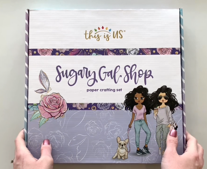Female hands pick up box and shows all contents from inside this Sugary Gal craft kit from Paper House Productions.