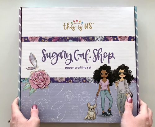 Female hands pick up box and shows all contents from inside this Sugary Gal craft kit from Paper House Productions.