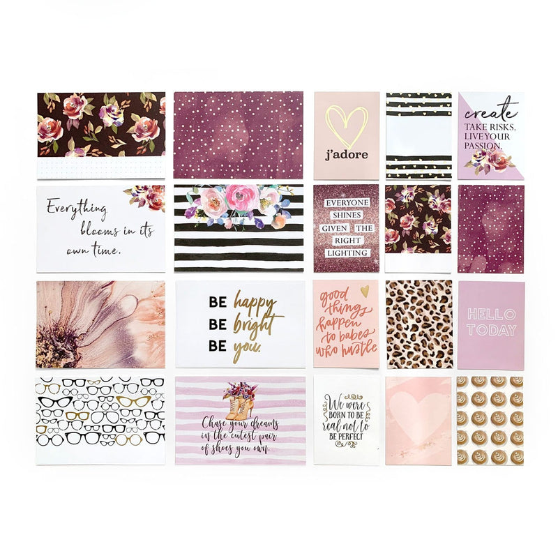 An assortment of paper tags feature inspirational words, florals, patterns and gold foil.