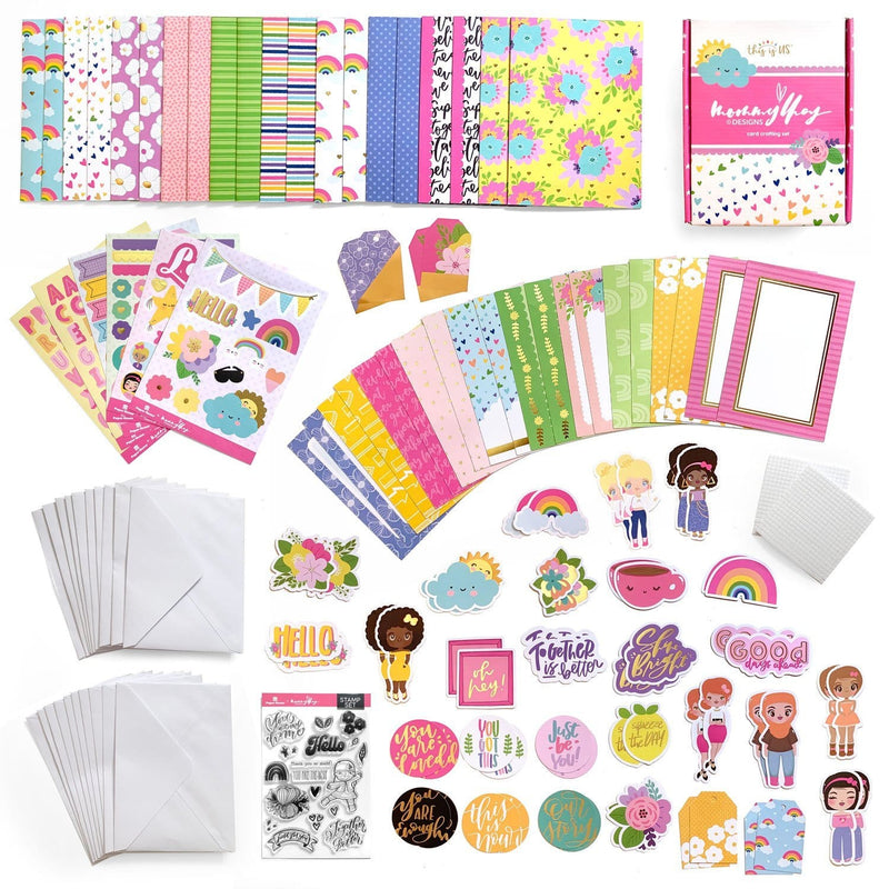 image shows full contents of the Mommy Lhey card making kit including paper, stickers, embellishments, stamps, and envelopes
