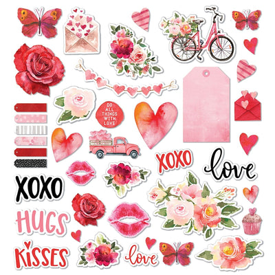 this craft kit image features an assortment of diecuts of red lips, hearts, flowers, words and bicycles shown on a white background.