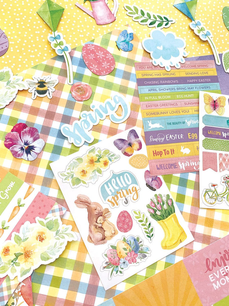 this craft kit image features close up of spring themed scrapbook papers, stickers and die cuts