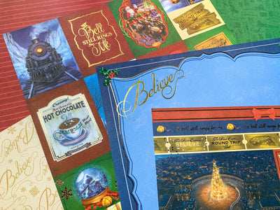 craft kit featuring close up of scrapbook papers with scenes and characters from the Polar Express movie, shown overlapping.
