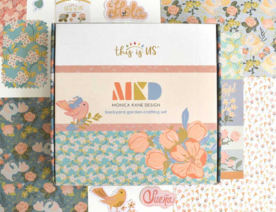Craft kit  featuring illustrated floral papers shown displayed with paper crafting kit packge
