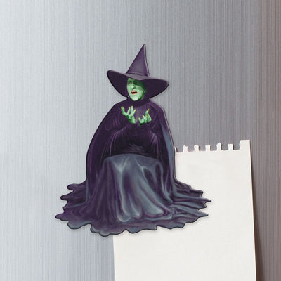 fridge magnet featuring the melting Wicked Witch of the West shown on a metal background attached to a sheet of torn memo paper.