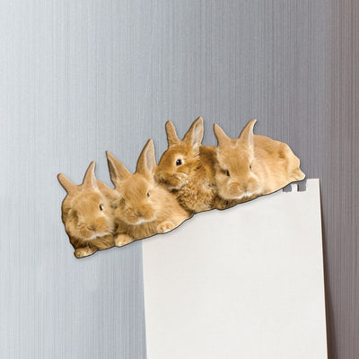 fridge magnet featuring 4 tan bunnies shown on metal background attached to a torn sheet of memo paper.