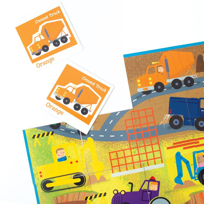 Trucks matching game for kids featuring close up of illustrated game board and 2 orange game cards, shown on white background.