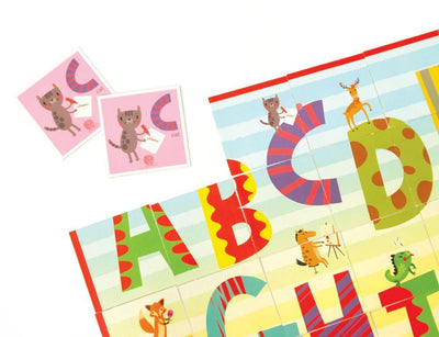 Close up of alphabet matching game for kids featuring the "C" cards with cute illustrations of a cat.