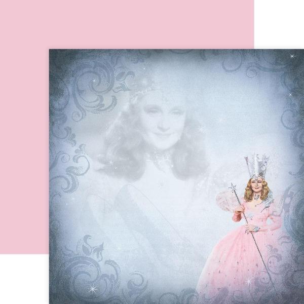scrapbook paper featuring Glinda from The Wizard Of Oz shown overlapping the solid pink opposite side.