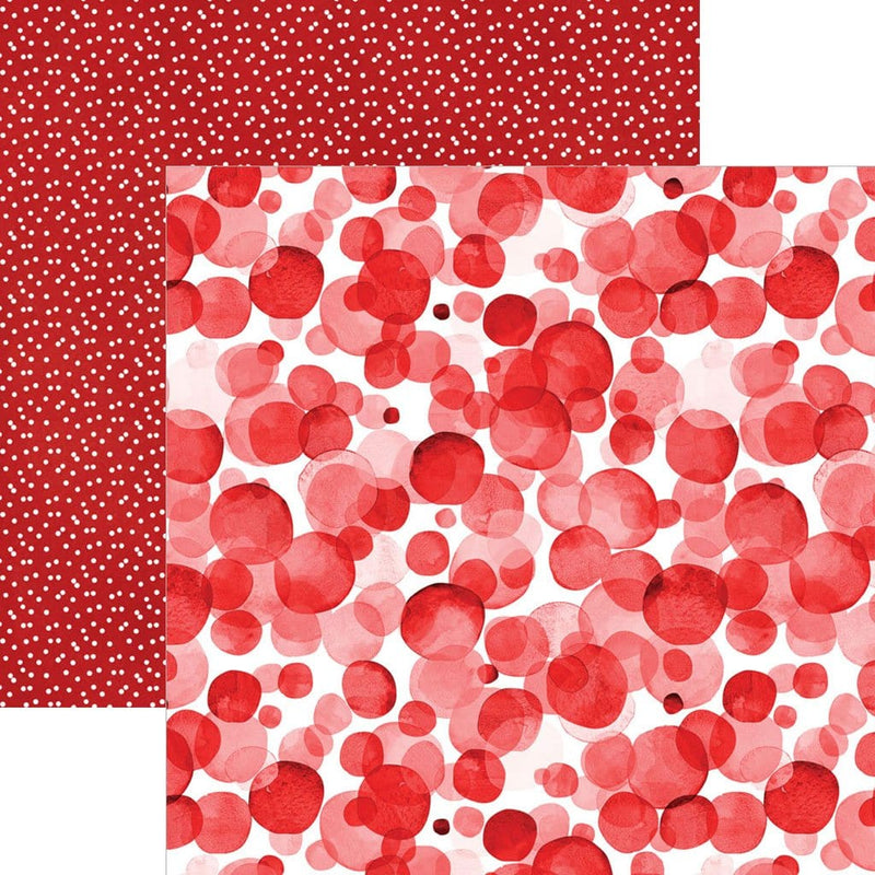 scrapbook paper image features a large red dot pattern on front side and a small white on red dot pattern on back side.