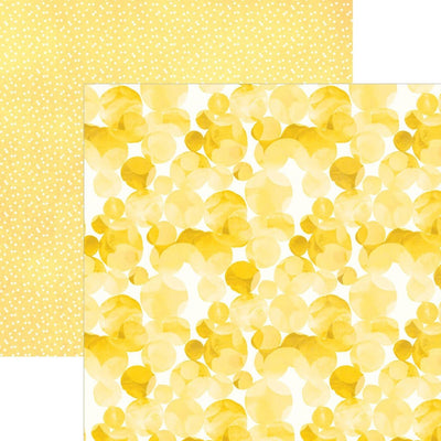 scrapbook paper image features a large yellow dot pattern on front side and a small white on yellow dot pattern on back side.