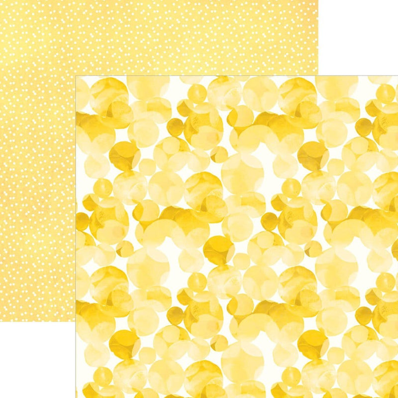 scrapbook paper image features a large yellow dot pattern on front side and a small white on yellow dot pattern on back side.