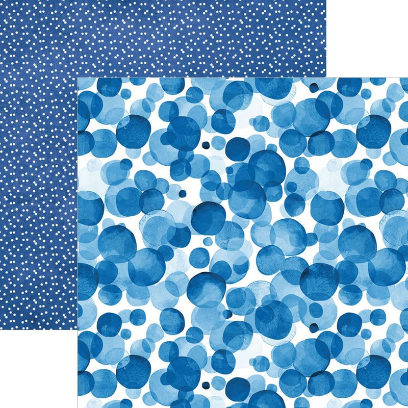 scrapbook paper image features a large blue dot pattern on front side and a small white on blue dot pattern on back side.