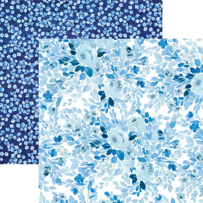 scrapbook paper image features large blue florals on front side and small blue florals on back side.