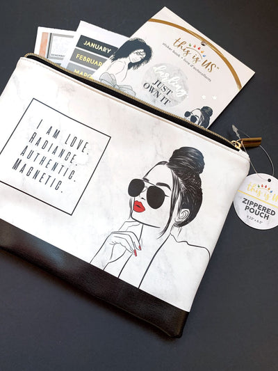 Black and white pencil pouch with gold zipper featuring an illustration of a woman with red lips and words of inspiration shown on a black background with related stickers in package.