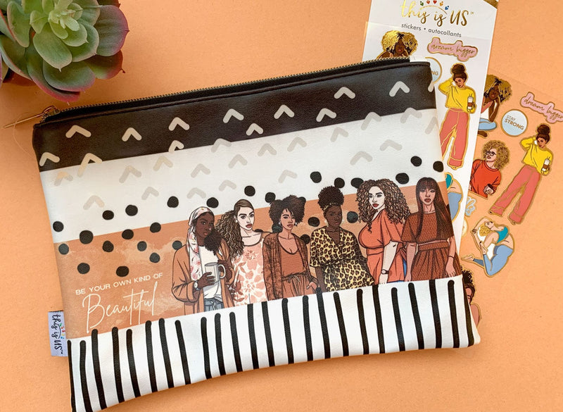 Black, white and tan pencil pouch with gold zipper featuring graphic patterns and an illustration of six diverse women with inspirational words shown on an orange background with related stickers.
