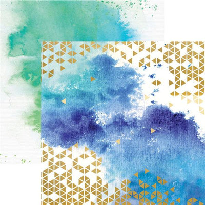 scrapbook paper featuring a blue watercolor pattern with gold foil pattern shown overlapping a teal watercolor pattern paper.