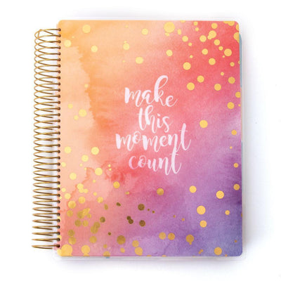 Make this Moment Count weekly planner image shows cover featuring white words, gold polka dots on a watercolor background with gold coil spine.