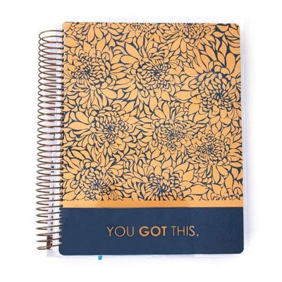 Brass Dahlia weekly planner image shows cover featuring gold floral pattern on dark blue background with gold words and gold coil spine.