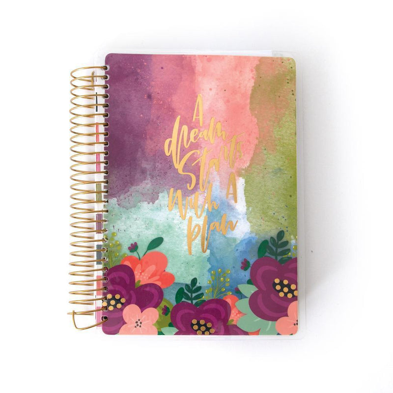Mini weekly planner image shows cover featuring colorful florals and a gold coil spine.