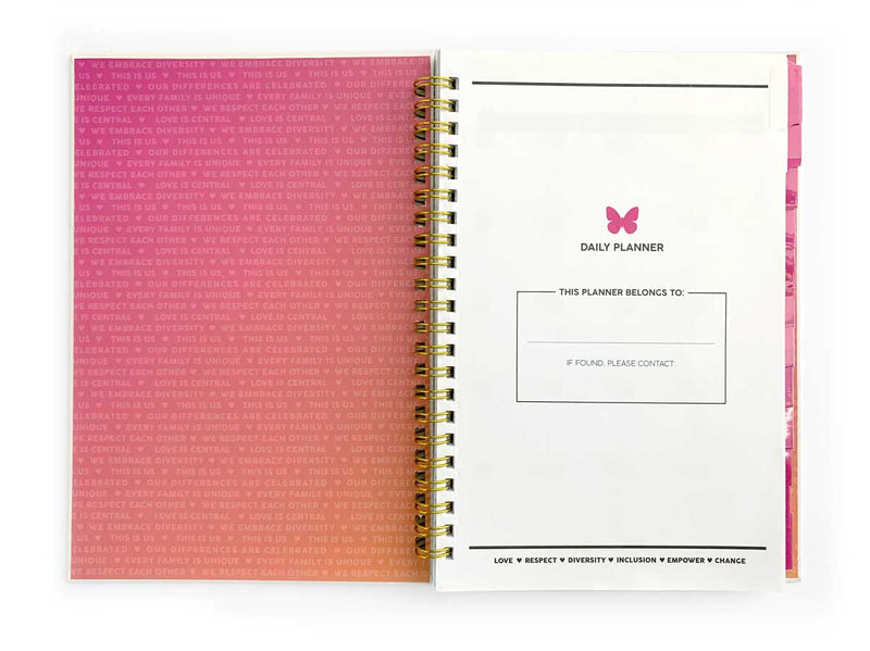 The inside cover and first page of a weekly planner featuring a pink gradient with positive words, shown open with a gold spiral and white title page with pink butterfly.