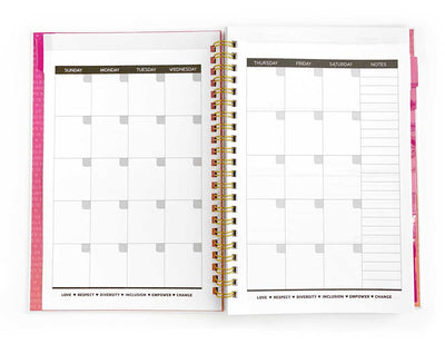 monthly spread of a weekly planner with gold spiral and pink covers, shown on white background.
