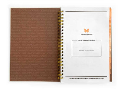 weekly planner shown open to the title page featuring a brown inside cover and white title page with orange butterfly.
