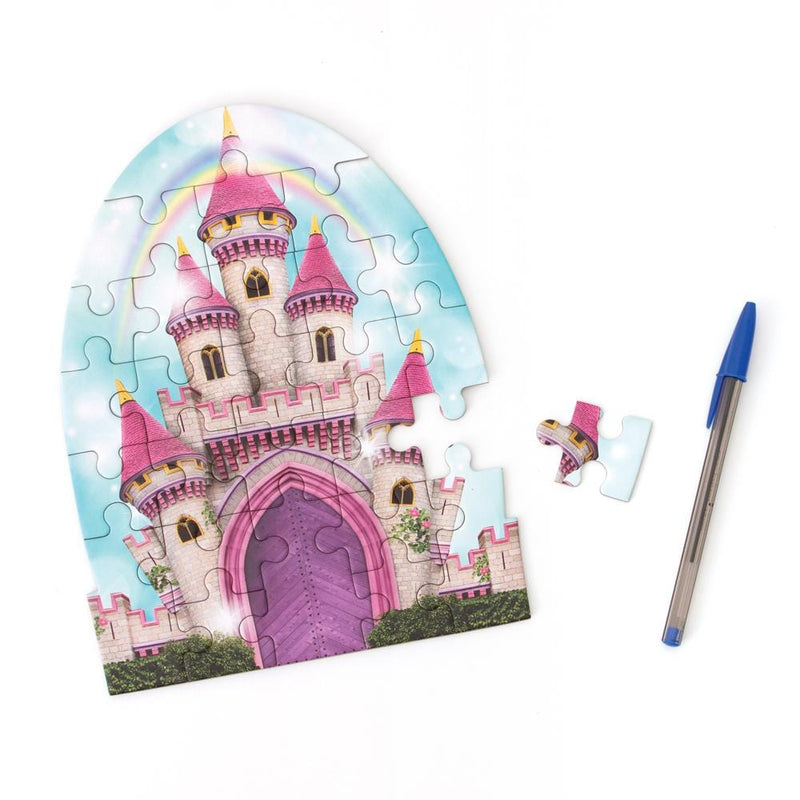 die cut mini jigsaw puzzle featuring an illustrated pink castle with rainbow, shown with pen and a separate piece on white background.