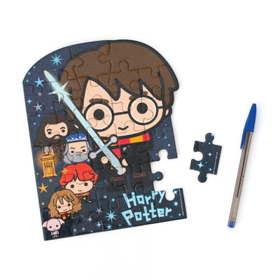 die cut mini jigsaw puzzle featuring chibi Harry Potter with pen and one separate piece on white background.
