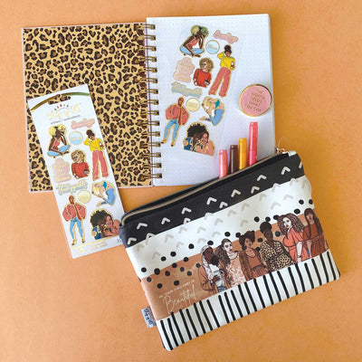 pencil pouch, spiral notebook and stickers featuring Goldmine and Coco designed women with cheetah prints, shown on orange background with 4 markers.