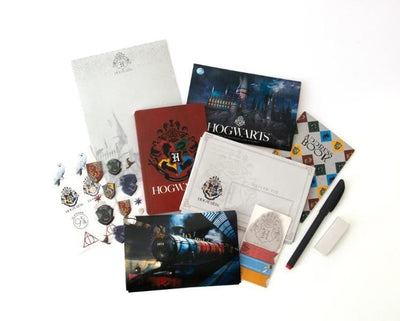 An assortment of kids stationery items are shown featuring the Harry Potter theme. An address book, hogwarts castle stationery and crest stickers are included.