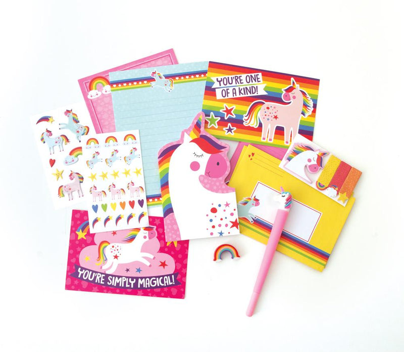 An assortment of kids stationery items are shown featuring rainbows and unicorns. Stickers, notecards, a pink unicorn pen and a rainbow-shaped eraser are all displayed.