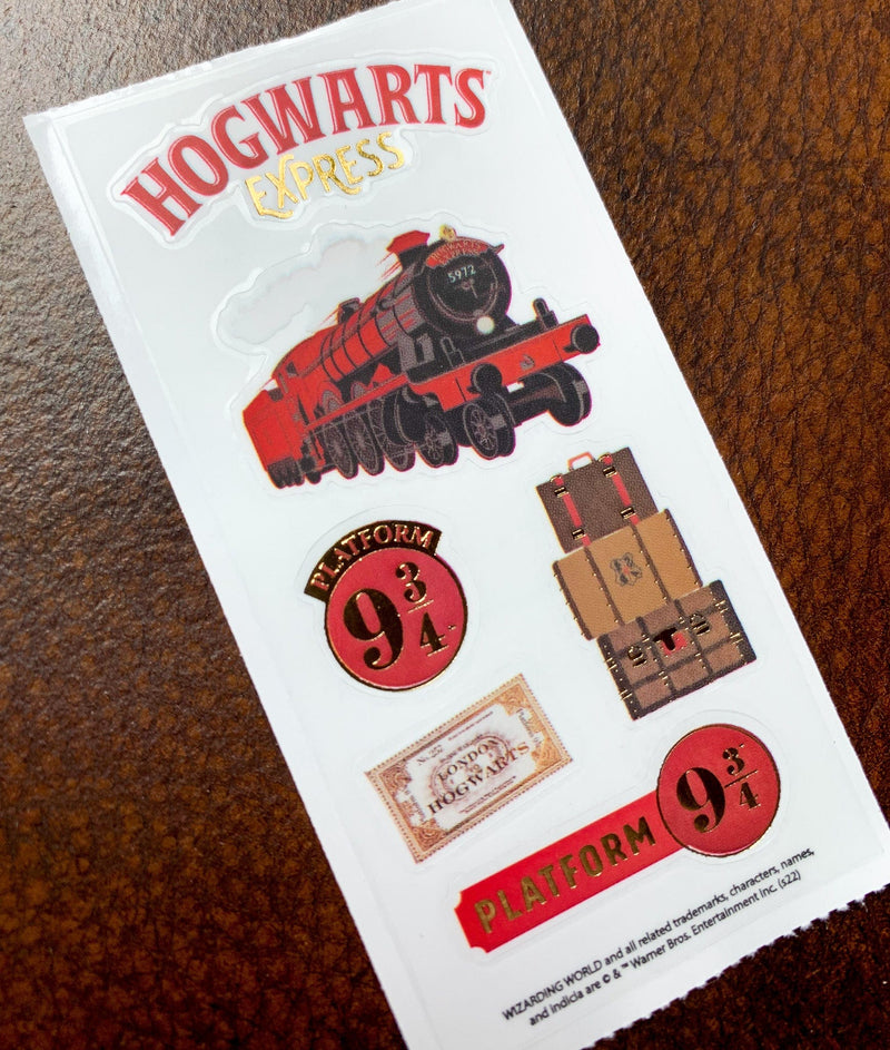 Sheet of Harry Potter stickers featuring the Hogwarts Express, luggage and the 9 3/4 platform sign, shown on a white background.