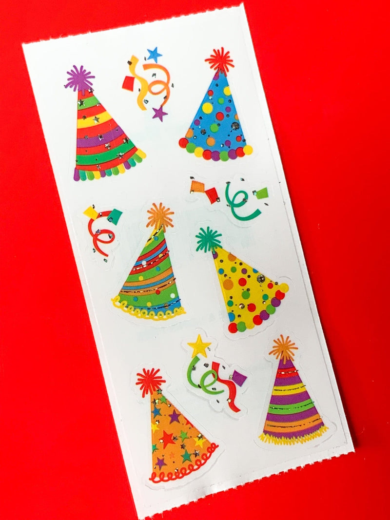 stickers featuring colorful party hats and confetti, shown on red background.