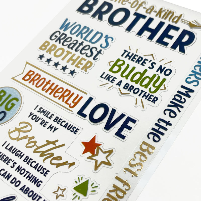 This image of scrapbook stickers shows the sticker sheet on an angle featuring sentiments of brotherly love with blue and gold details.