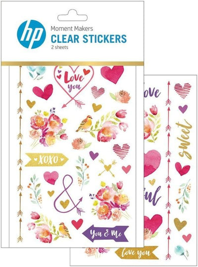 clear scrapbook stickers featuring watercolor hearts, flowers and arrows, shown in package overlapping another sheet of stickers shown on white background.