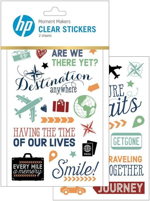 scrapbook stickers featuring illustrations of airplanes, luggage, cameras and words of travel, shown in package overlapping another sheet of stickers on white background.