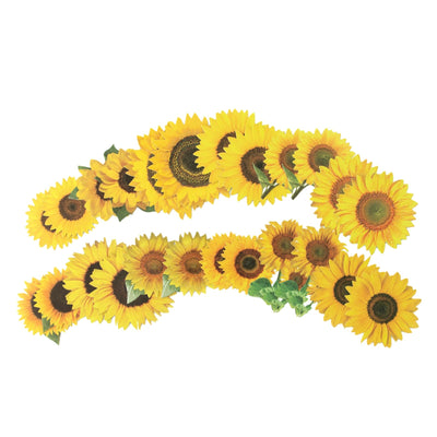 An assortment of scrapbook stickers featuring yellow sunflowers fanned out on a white background.