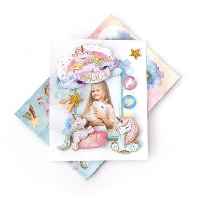 3D scrapbook stickers featuring a photo of a girl with a unicorn in a frame surrounded by illustrated unicorns and rainbows shown above a sheet of stickers on a white background.
